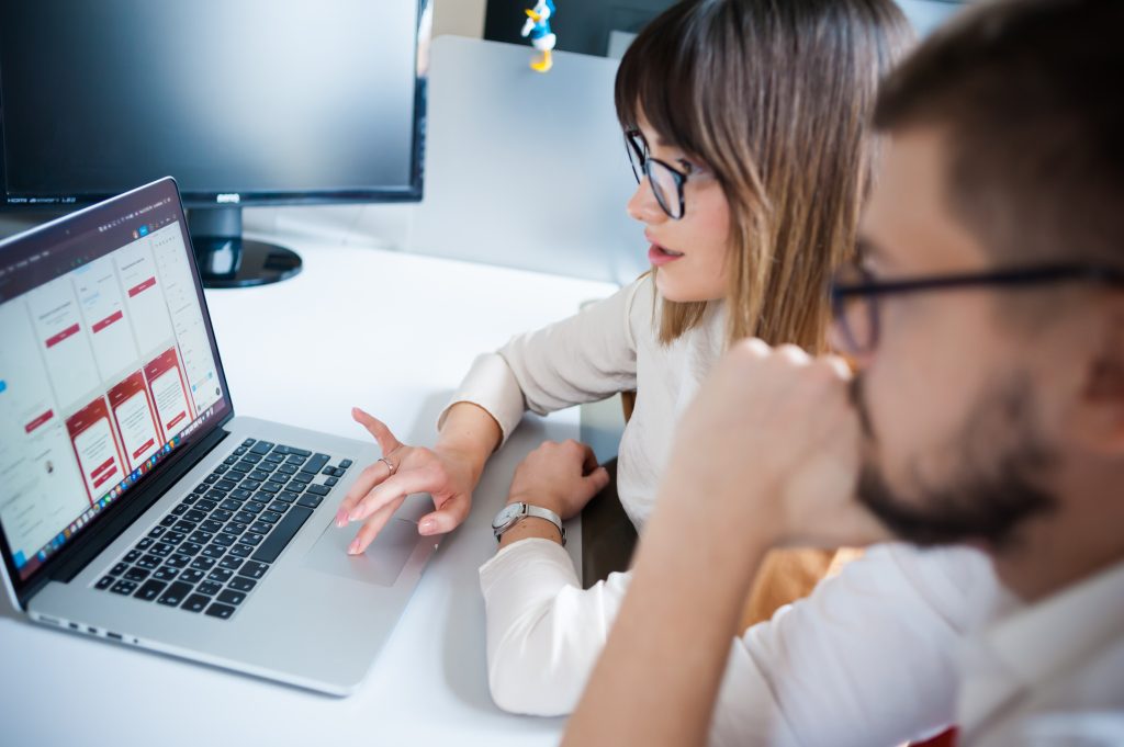 Young Coworkers Using Laptop Office